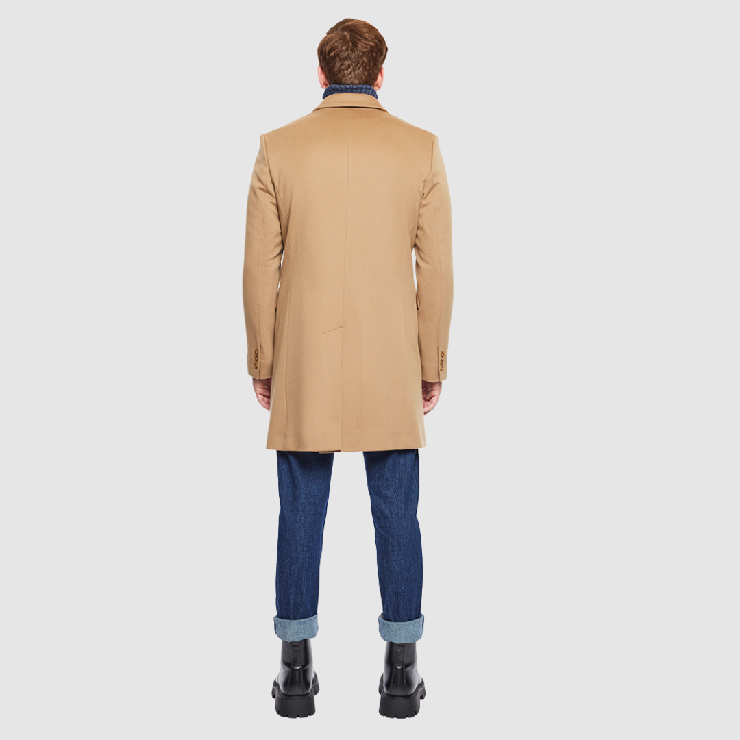 The Dylan Camel Loro Piana Wool Coat captures refined sophistication through meticulous tailoring and Italian craftsmanship. Made from Loro Piana superfine wool, this single-breasted coat offers a slim fit through the arms and body, creating a sharp, modern silhouette ideal for both professional and evening wear. The notch collar, button-detailed cuffs, and flap side pockets add subtle sophistication, while the back vent ensures ease of movement and comfort. A single welt chest pocket completes this timeles
