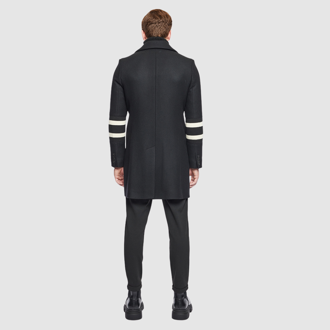 The Sebastian Black Wool Rugby Coat is a tailored Italian wool cashmere blend jacket designed for refined cold-weather style. Featuring regular shoulders and a fitted cut through the arms and chest, it offers a structured silhouette that balances classic tailoring with modern menswear appeal. Details like the spread collar, knit stripe accents on the sleeves, and single welt pockets provide a subtle, heritage-inspired touch. Single-breasted button closure ensures clean lines, make Sebastian ideal for layers