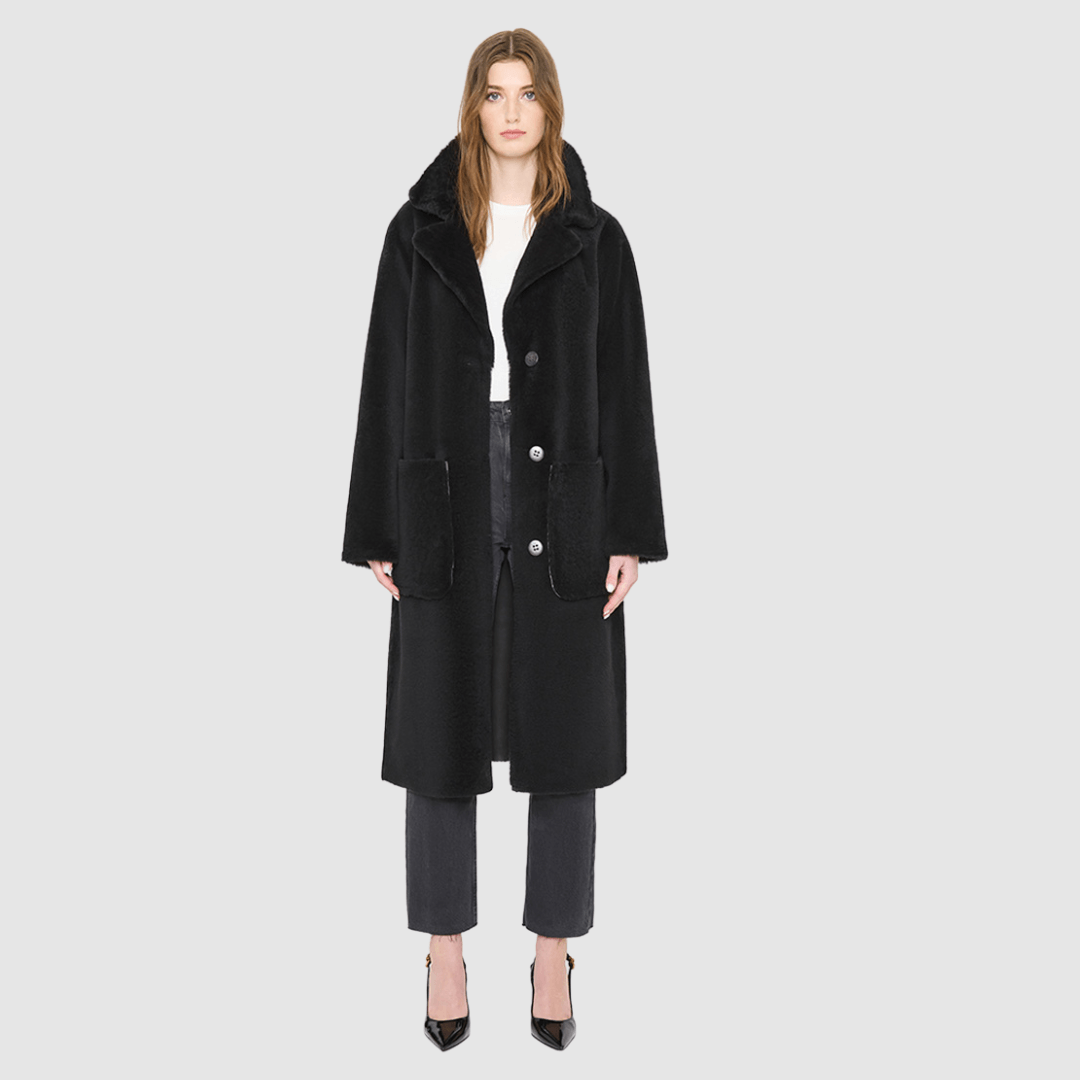 The ZIRA Coat is a heritage-inspired vintage reversible shearling jacket crafted in java nappa and iron wool. Designed to flip effortlessly from sleek nappa to plush iron wool teddy, it delivers versatile styling for both après-ski sophistication and everyday cold-weather elegance. Featuring a relaxed dropped shoulder, notch collar, and 3-button closure, ZIRA combines modern tailoring with timeless texture. Practical zip pockets on the nappa side and patch pockets on the teddy side