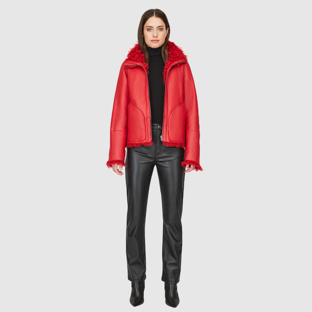 This cropped teddy jacket features a reversible design, with wool-out on one side and nappa-out on the other. The relaxed shoulder, spread collar, and slash side pockets provide comfort and functionality, while the front zip closure adds a practical touch.