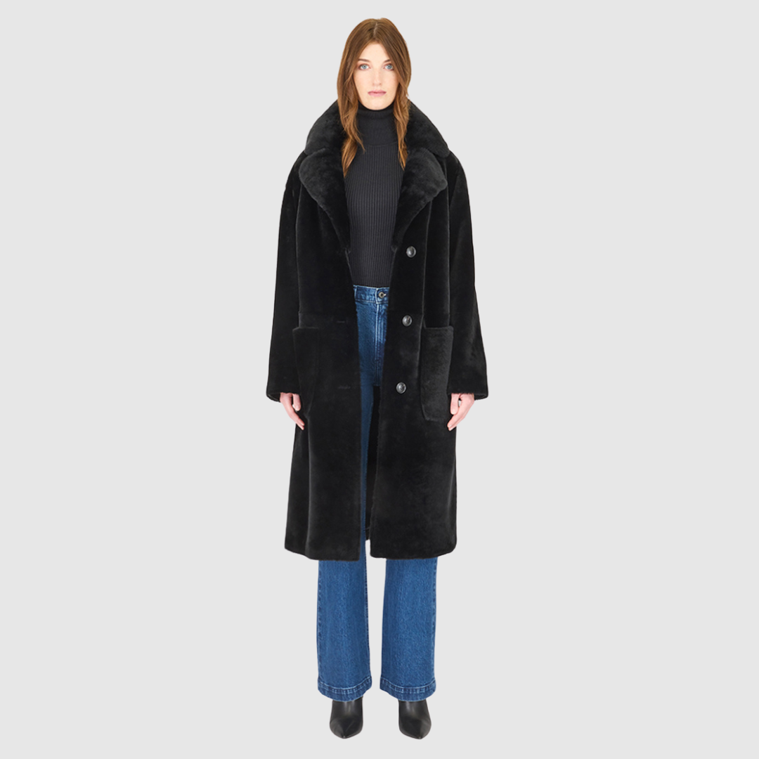 This timeless HiSO Prado Jet Iron Wool Coat features vintage-inspired design elements such as a notch collar, relaxed dropped shoulder, and a tie belt at the waist. It also boasts practicality with large side patch pockets and a front button closure.