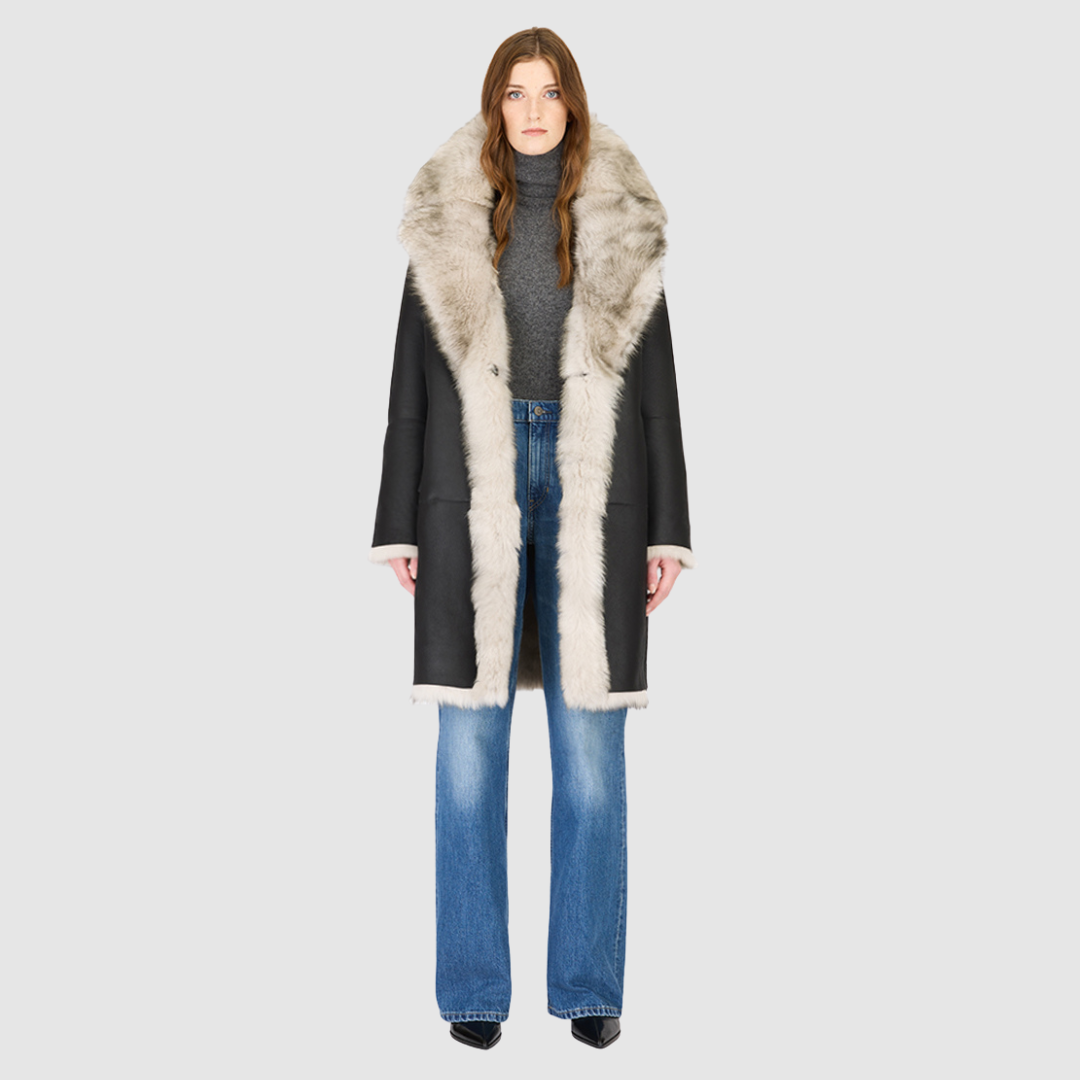 The JOY Jacket is a heritage-inspired reversible outerwear piece crafted in yingyang Toscana shearling. Designed to flip seamlessly from plush oversized teddy to sleek suede, it offers versatile styling for both après-ski sophistication and everyday winter elegance. With a drop shoulder, large notch collar, and oversized silhouette, JOY combines comfort with modern edge. Functional slash side pockets on the teddy side and single welt pockets on the nappa side, along with a front button closure.