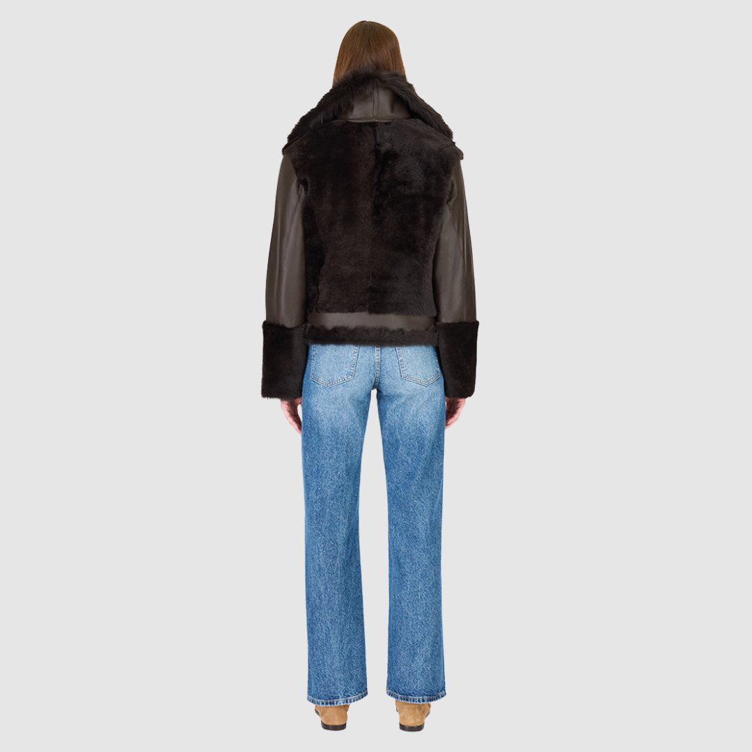 Soft wool on sleek nappa moto Drop shoulder Wool out cuff detail & sheared wool body and sleeves Toscana long wool collar with double buckle detail Asymmetrical front zip closure Side and interior zip pockets