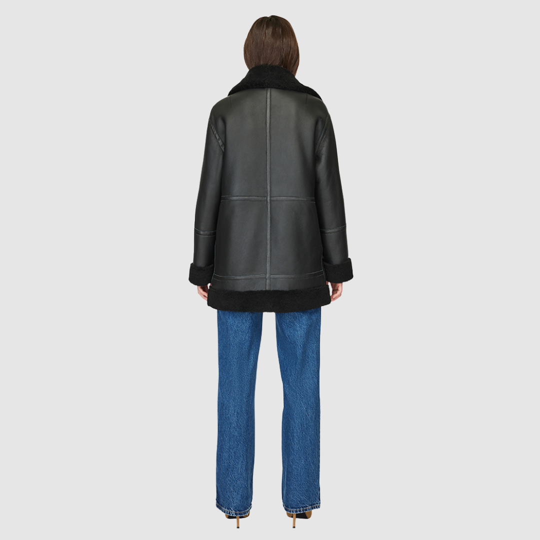 The DEZ Jacket is a heritage-inspired reversible medium-length shearling moto crafted in jet nappa leather with plush curly wool teddy on the reverse. Designed for a relaxed silhouette with drop shoulders, curly wool collar and trims, and a straight fit, DEZ combines modern edge with timeless texture. Functional patch pockets on both nappa and wool sides and a front zip closure make this jacket as practical as it is versatile, perfect for après-ski layering or elevated city styling.