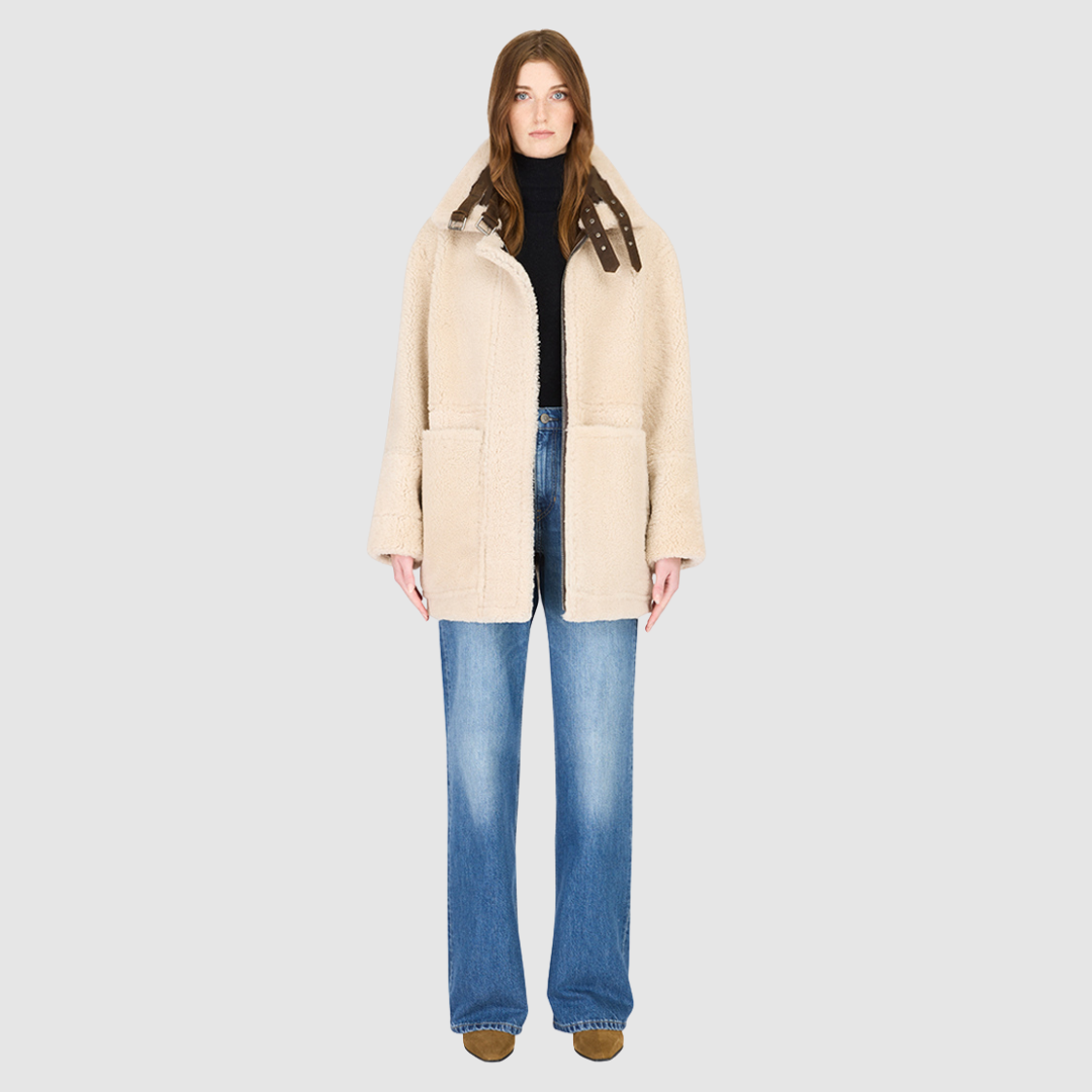 The DEZ Jacket is a heritage-inspired reversible medium-length shearling moto crafted in arabica suede leather with plush curly wool teddy on the reverse. Designed for a relaxed silhouette with drop shoulders, curly wool collar and trims, and a straight fit, DEZ combines modern edge with timeless texture. Functional patch pockets on both suede and wool sides and a front zip closure make this jacket as practical as it is versatile, perfect for après-ski layering or elevated city styling.