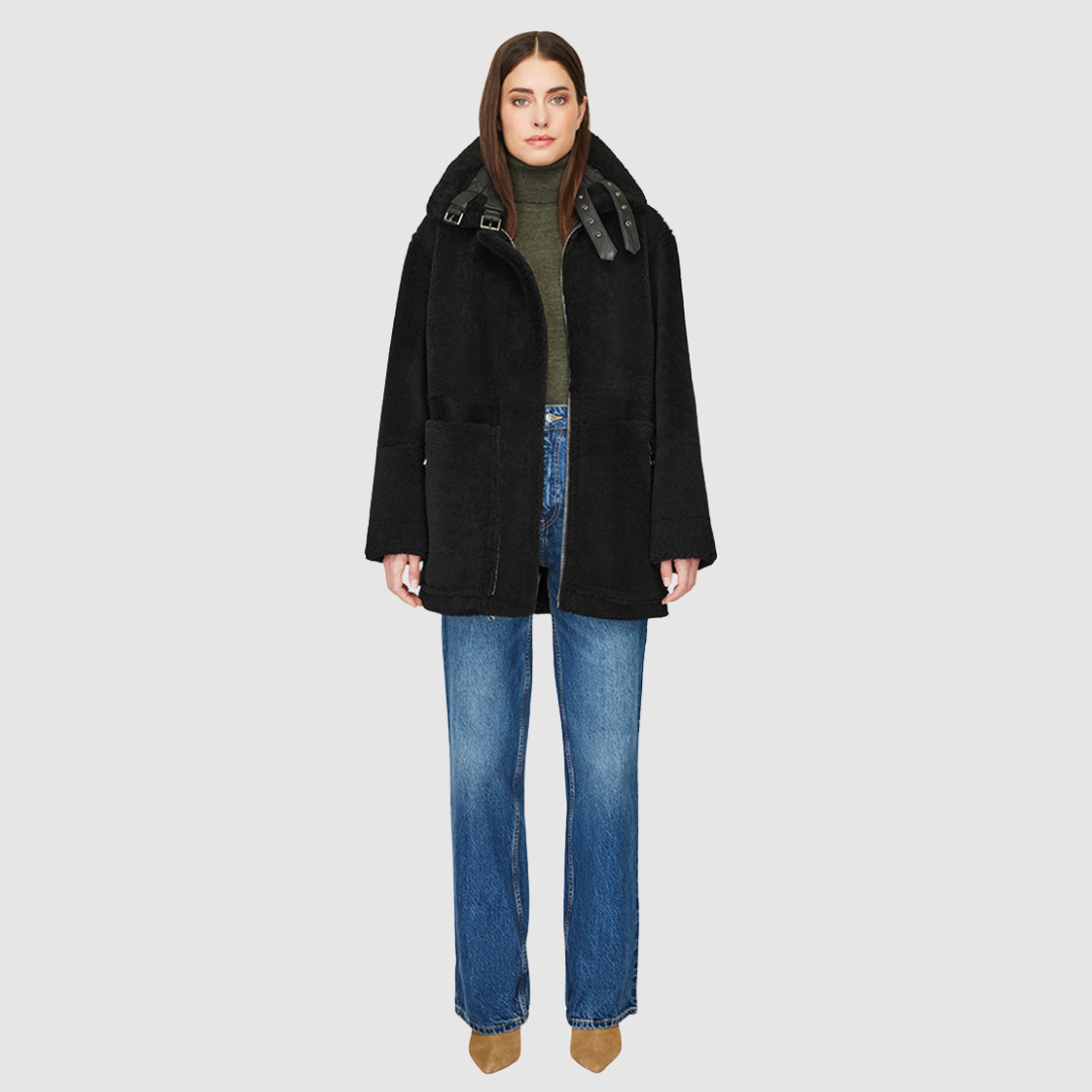 The DEZ Jacket is a heritage-inspired reversible medium-length shearling moto crafted in jet nappa leather with plush curly wool teddy on the reverse. Designed for a relaxed silhouette with drop shoulders, curly wool collar and trims, and a straight fit, DEZ combines modern edge with timeless texture. Functional patch pockets on both nappa and wool sides and a front zip closure make this jacket as practical as it is versatile, perfect for après-ski layering or elevated city styling.