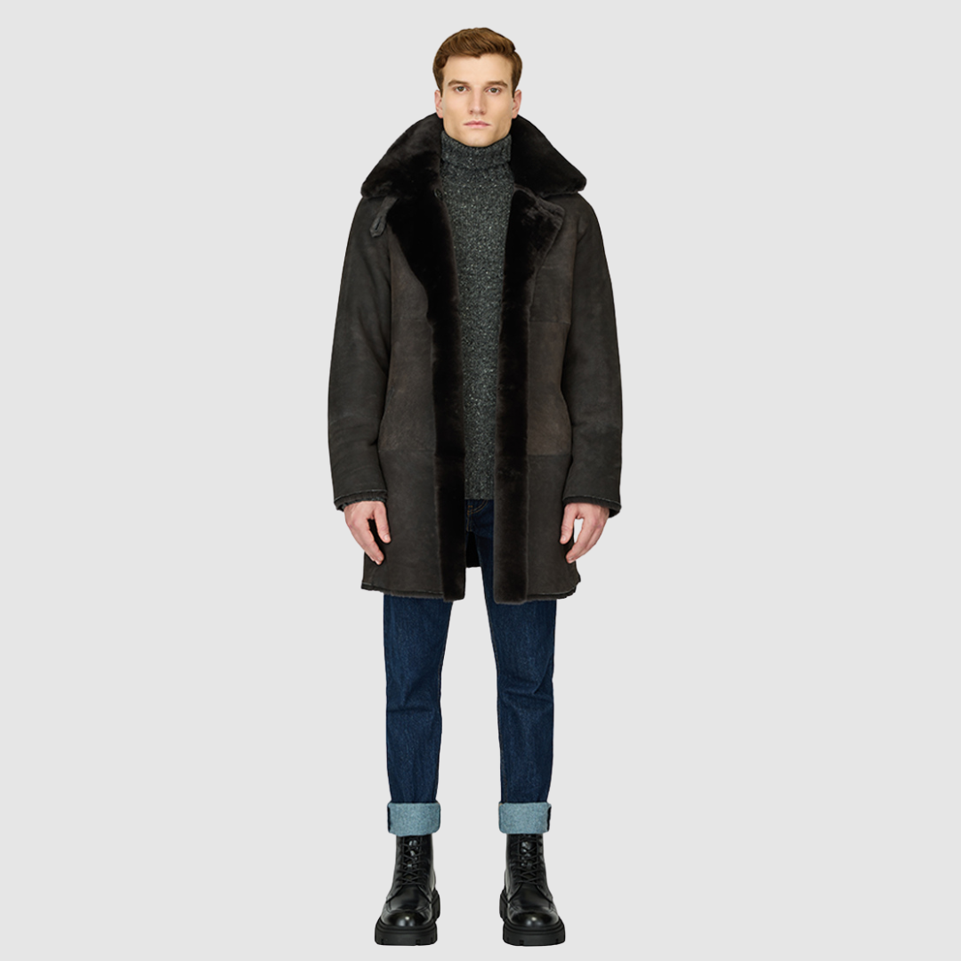 The Edson Black Vintage Reversible Shearling Jacket is a mid-length men’s coat engineered for winter warmth and versatile styling. Crafted from luxe suede with a plush ironed wool teddy reverse, it delivers two distinct silhouettes: structured and tailored when suede-out, or relaxed and oversized when wool-out. Designed with a spread collar, raw edge detailing, and functional dual pockets, this jacket provides effortless layering and superior cold-weather protection. Edson balances timeless shearling crafts