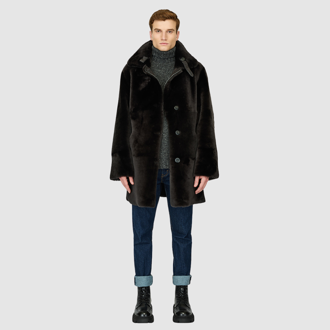 The Edson Black Vintage Reversible Shearling Jacket is a mid-length men’s coat engineered for winter warmth and versatile styling. Crafted from luxe suede with a plush ironed wool teddy reverse, it delivers two distinct silhouettes: structured and tailored when suede-out, or relaxed and oversized when wool-out. Designed with a spread collar, raw edge detailing, and functional dual pockets, this jacket provides effortless layering and superior cold-weather protection. Edson balances timeless shearling crafts