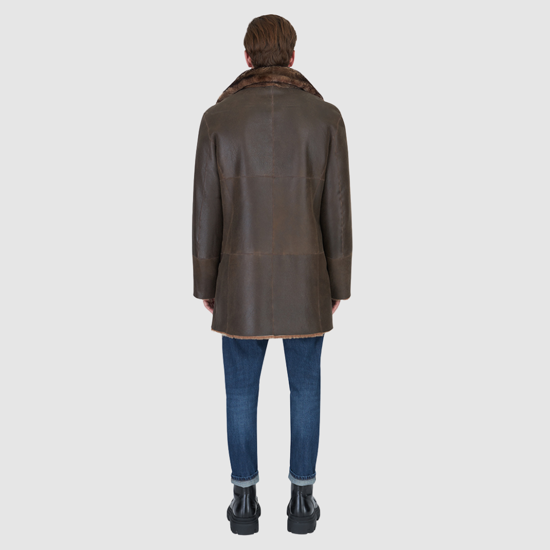 The Edson Burma Reversible Shearling Jacket is a mid-length men’s coat engineered for winter warmth and versatile styling. Crafted from luxe nappa with a plush ironed wool teddy reverse, it delivers two distinct silhouettes: structured and tailored when nappa-out, or relaxed and oversized when wool-out. Designed with a spread collar, raw edge detailing, and functional dual pockets, this jacket provides effortless layering and superior cold-weather protection. Edson balances timeless shearling craftsmanship