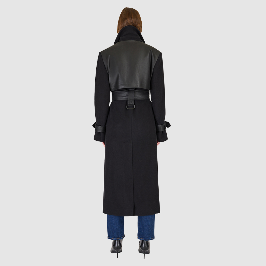 The EVERLY – Black coat is a statement outerwear piece crafted from a premium Italian wool-cashmere blend. This structured coat features a notch collar, leather tie belt at the waist, and refined leather accents at the cuffs, storm back, and welt pockets. A back vent ensures comfort and movement, while the tailored silhouette delivers timeless sophistication. Perfect as a luxury winter coat or everyday wool jacket, the EVERLY defines modern elegance with edge.