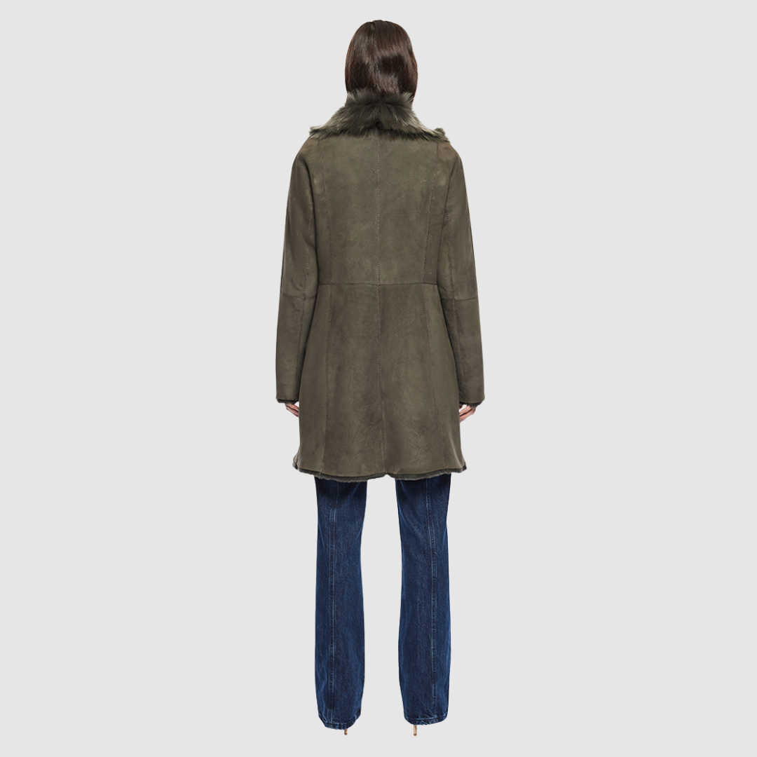 The GIPSI Reversible Shearling Jacket offers a modern take on the parka, combining rugged function with luxurious texture. Crafted in khaki suede that reverses to a plush Toscana wool teddy, it delivers two distinct looks in one. Designed with a regular shoulder and oversized Toscana notch collar, it balances structure with relaxed ease. Raw-edge hems and versatile pocketing lend utility to this semi-fitted style, making GIPSI ideal for heritage outerwear lovers and après-ski wardrobes alike.