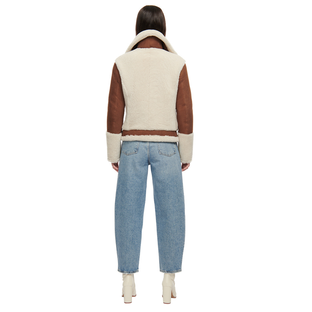 Nappa curly wool shearling moto Drop shoulder Wool out cuff detail & sheared wool body and sleeves Curly wool collar with double buckle detail Asymmetrical front zip closure Side and interior zip pockets