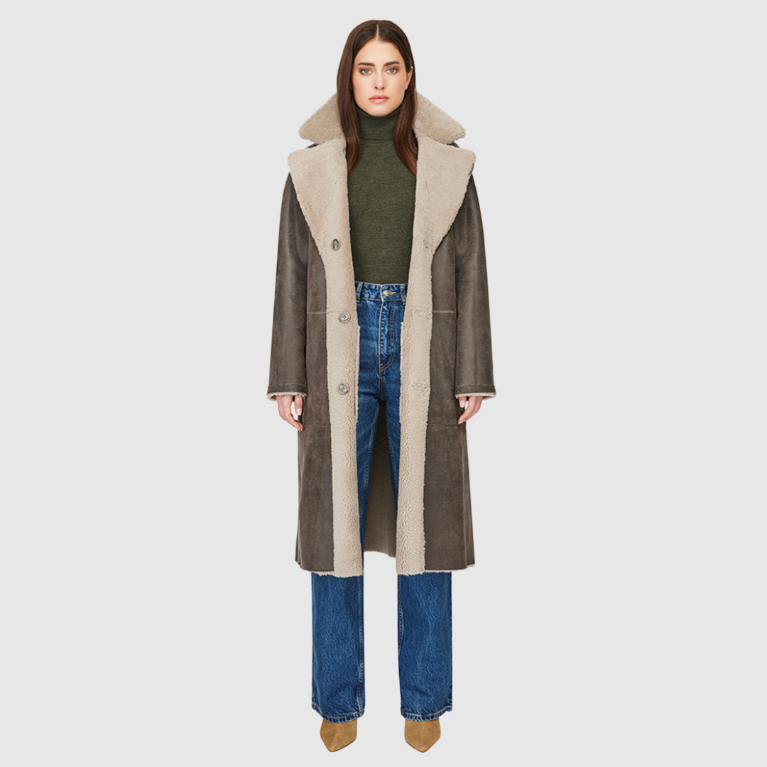 Introducing Zira, our vintage-inspired reversible nappa curly wool shearling coat. This elegant piece features a classic notch collar and effortlessly reverses to a cozy curly wool teddy. Designed with a relaxed dropped shoulder, 3-button closure, and a tie belt at the waist for a flattering fit, it offers both style and comfort. Practical zip pockets on the nappa side reverse to patch pockets on the teddy side, making Zira a versatile must-have for winter fashion.