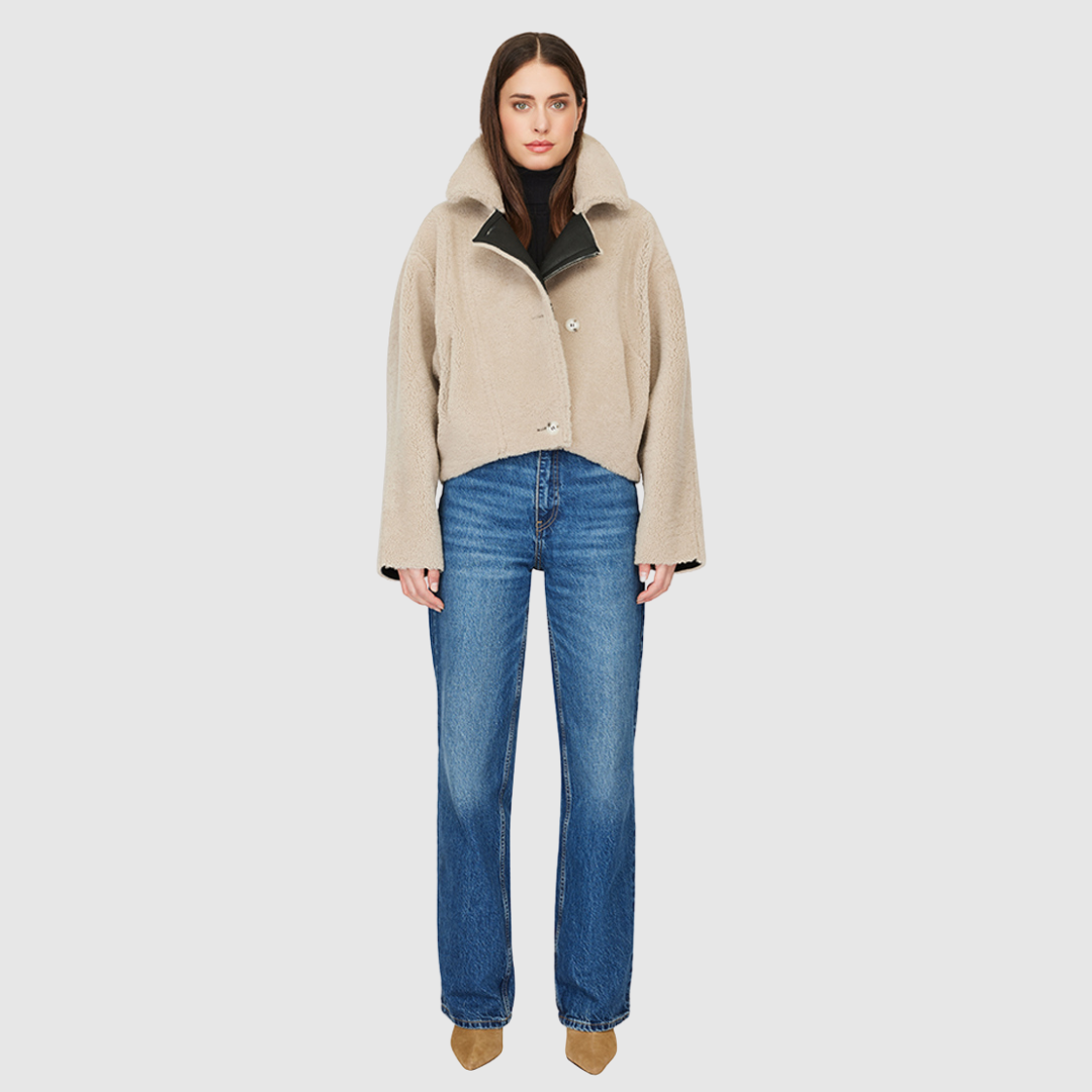 Reversible nappa cropped relaxed moto Reverses to curly wool teddy Drop shoulder Relaxed bat wing sleeves Oversized notch collar Single welt side pockets on nappa side Slash pockets on curly wool side Asymmetrical front zip and single button closure