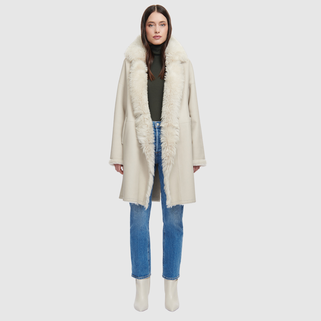 The August Ivory Reversible Shearling Jacket is a versatile outerwear staple that blends refined tailoring with modern ease. Crafted in supple nappa leather, it reverses to an ironed wool teddy for a completely different look and feel. Designed with a slightly dropped shoulder and a loose, relaxed silhouette, it’s finished with a double-breasted button closure for a polished yet effortless finish.