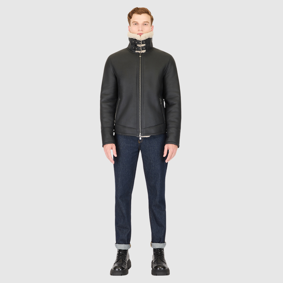 The Code Black Beige Shearling Moto is a bold reinterpretation of a classic moto jacket, merging sleek nappa leather with plush curly wool shearling. Designed for a true-to-size fit, it features a spread collar with a buckle detail for added edge, a standard front zip closure, and an interior zip pocket for functionality. This piece balances rugged refinement with modern versatility, making it a cold-weather essential.