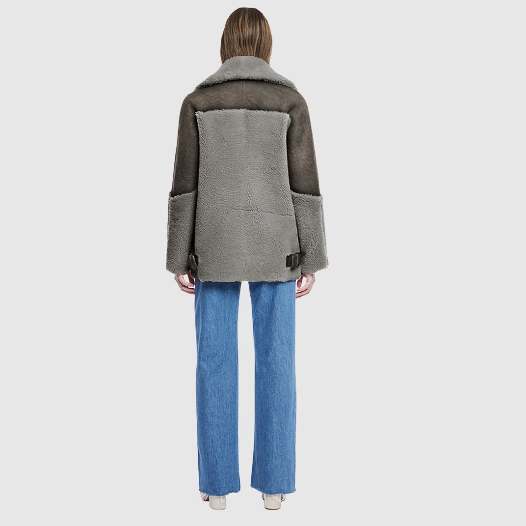 Curly wool and nappa mixed media coat Drop shoulder Oversized loose fitted style Curly wool detail on body and sleeve cuff Deep armhole and wide sleeves Straight fit Asymmetrical front zip closure Exterior zip pockets Hidden inside pockets