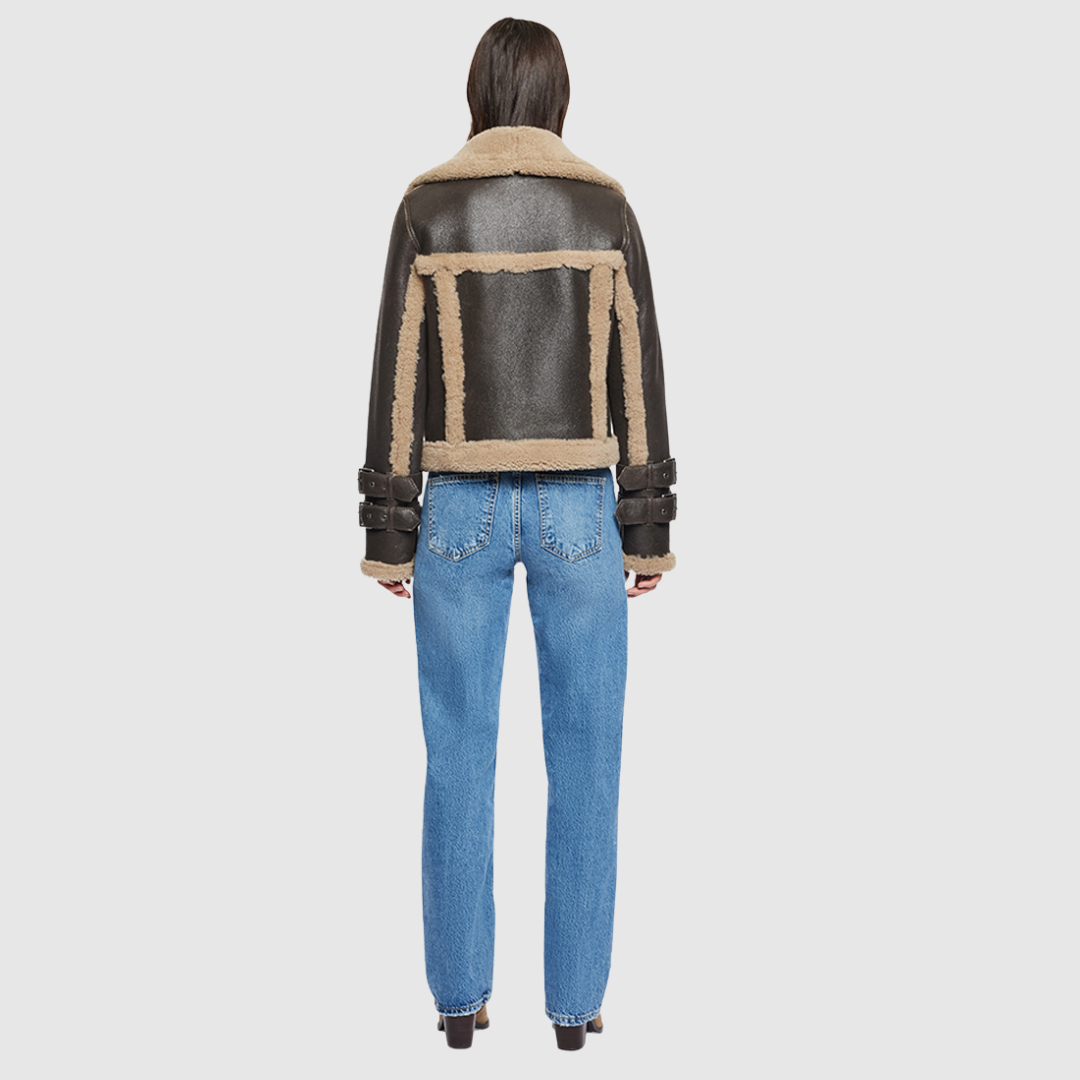 This cropped biker jacket is updated with contrasting wool seams. Crafted in genuine shearling, the jacket is finished with zip pockets and buckle accents at the collar and cuffs. Genuine Shearling Spread collar Long-sleeve Zipper closure Imported