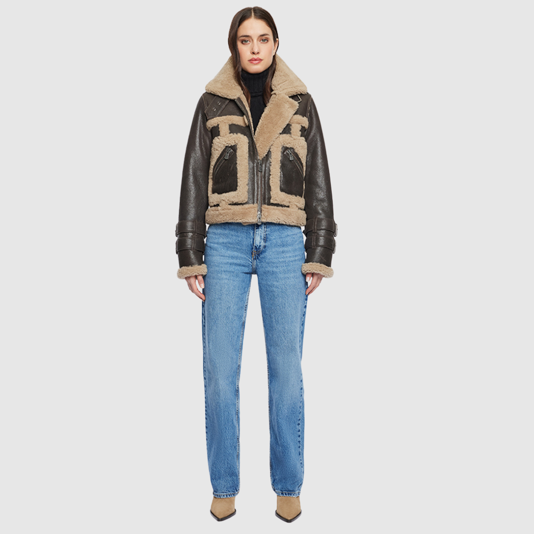 This cropped biker jacket is updated with contrasting wool seams. Crafted in genuine shearling, the jacket is finished with zip pockets and buckle accents at the collar and cuffs. Genuine Shearling Spread collar Long-sleeve Zipper closure Imported