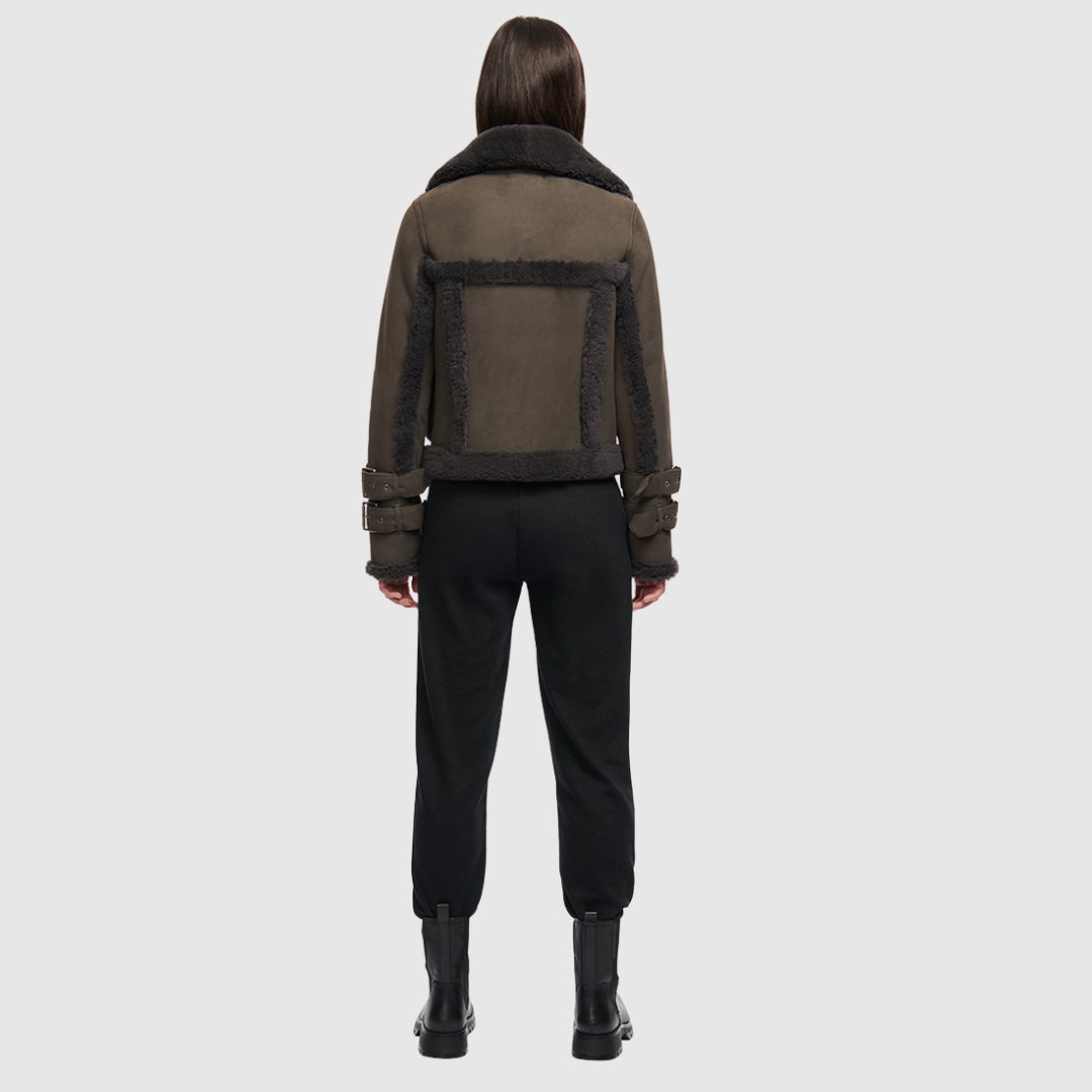 This cropped biker jacket is updated with contrasting wool seams. Crafted in genuine shearling, the jacket is finished with zip pockets and buckle accents at the collar and cuffs. Genuine Shearling Spread collar Long-sleeve Zipper closure Imported