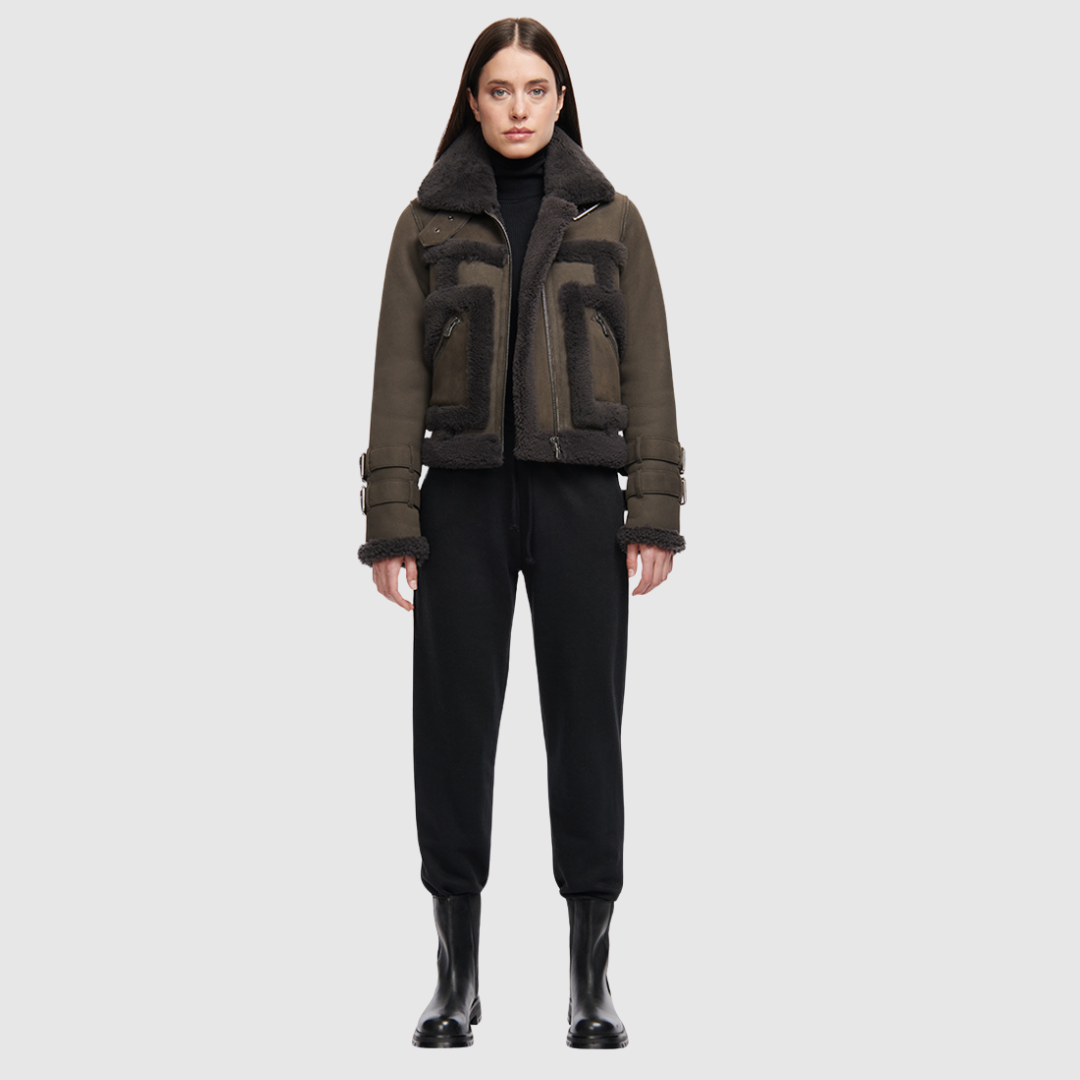This cropped biker jacket is updated with contrasting wool seams. Crafted in genuine shearling, the jacket is finished with zip pockets and buckle accents at the collar and cuffs. Genuine Shearling Spread collar Long-sleeve Zipper closure Imported
