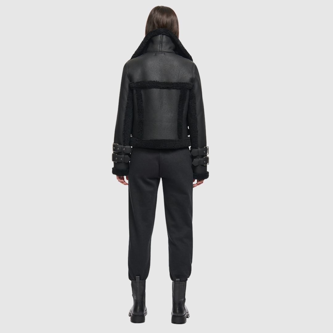This cropped biker jacket is updated with contrasting wool seams. Crafted in genuine shearling, the jacket is finished with zip pockets and buckle accents at the collar and cuffs. Genuine Shearling Spread collar Long-sleeve Zipper closure Imported