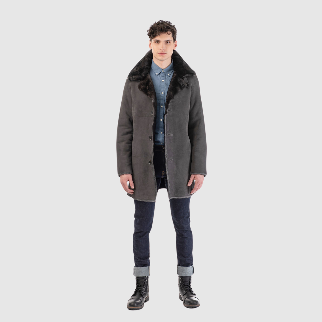 Reversible shearling suede medium length coat Reverses back to iron wool teddy Fits true to size when worn skin out Fits looser when worn wool out Raw edge finish Spread collar with tab Single welt side pocket on suede side Slash side pocket on iron wool side Single breasted button closure