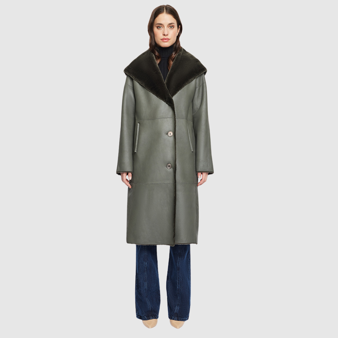The EVER Reversible Shearling Coat is designed for maximum versatility and modern elegance. Crafted in khaki nappa that reverses to plush ironed wool, it offers two distinct styling options in one oversized silhouette. An oversized hood that converts to a dramatic shawl collar adds functional sophistication, while raw-edge finishing gives it a contemporary edge. With its drop shoulder and pull-through pockets, EVER is a refined statement piece perfect for heritage styling and après-ski layering.