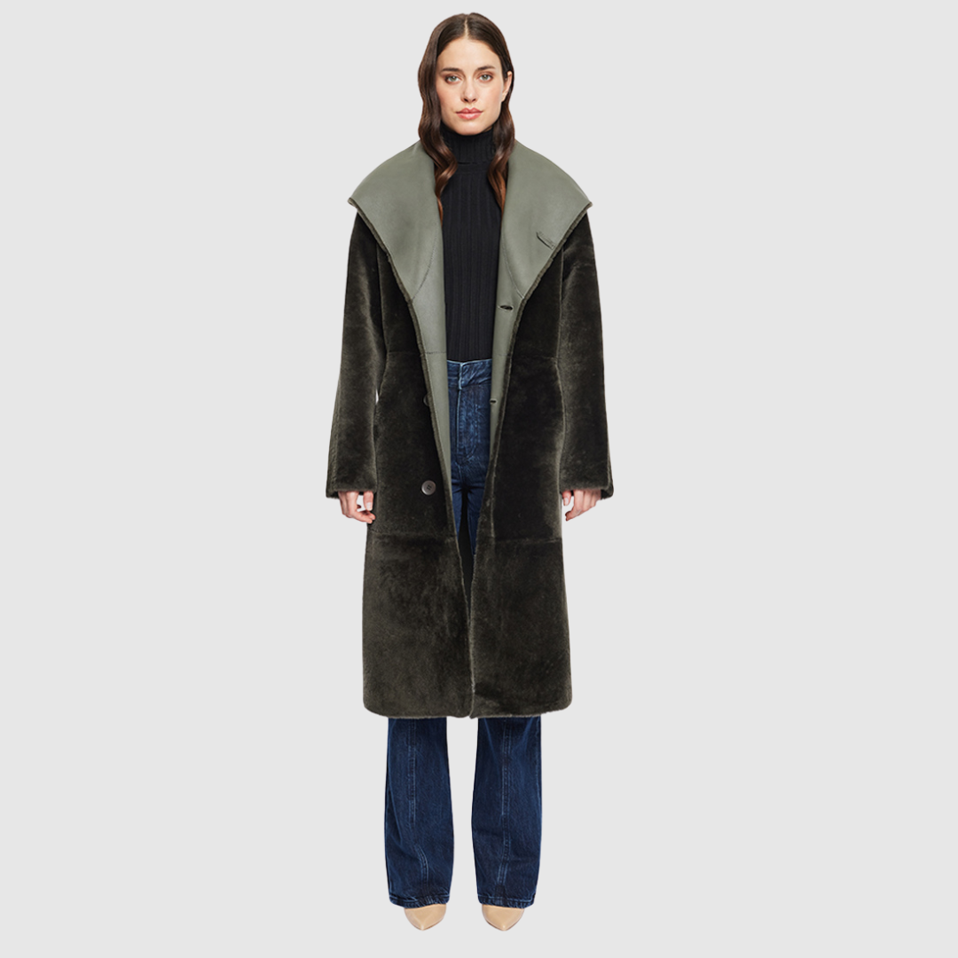 The EVER Reversible Shearling Coat is designed for maximum versatility and modern elegance. Crafted in khaki nappa that reverses to plush ironed wool, it offers two distinct styling options in one oversized silhouette. An oversized hood that converts to a dramatic shawl collar adds functional sophistication, while raw-edge finishing gives it a contemporary edge. With its drop shoulder and pull-through pockets, EVER is a refined statement piece perfect for heritage styling and après-ski layering.