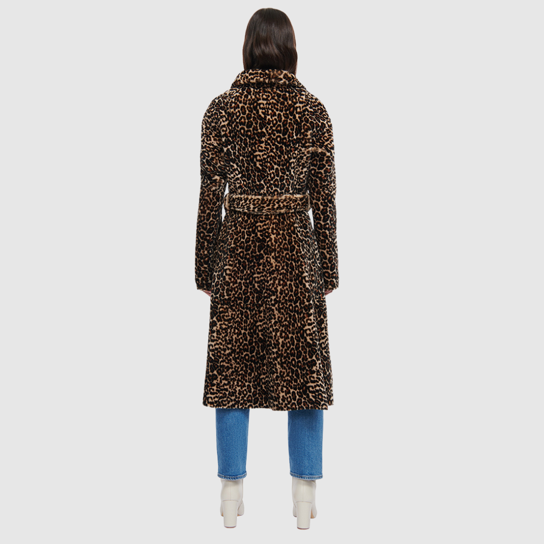 The HARLEY Shearling Coat brings a bold twist to classic outerwear with its striking snow leopard print in plush mouton wool. Cut to a knee length with a fitted A-line silhouette, it offers a flattering shape while delivering heritage-level warmth. A notch collar and clean three-button front with a tie wrap closure add refined structure, while slash pockets provide everyday practicality. Designed for those who favor statement outerwear, HARLEY blends après-ski glamour with timeless sophistication.