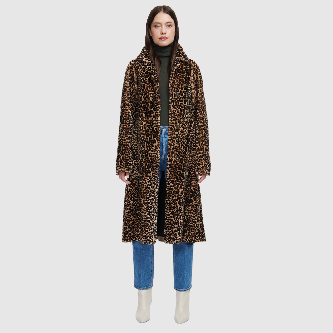 The HARLEY Shearling Coat brings a bold twist to classic outerwear with its striking snow leopard print in plush mouton wool. Cut to a knee length with a fitted A-line silhouette, it offers a flattering shape while delivering heritage-level warmth. A notch collar and clean three-button front with a tie wrap closure add refined structure, while slash pockets provide everyday practicality. Designed for those who favor statement outerwear, HARLEY blends après-ski glamour with timeless sophistication.