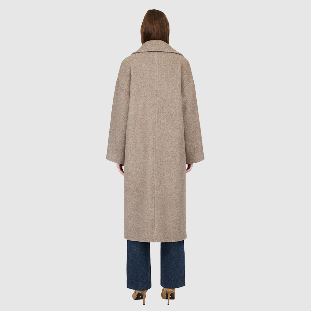 The ISABELLA Taupe Wool Coat is crafted from a luxurious Italian wool-cashmere blend, designed with a relaxed, oversized silhouette. Its double-breasted closure and drop-shoulder construction create an effortlessly modern drape, while kimono gusset sleeves add fluidity and ease of movement. A large notch collar and single welt pockets complete the look, making ISABELLA a timeless statement piece in contemporary outerwear.