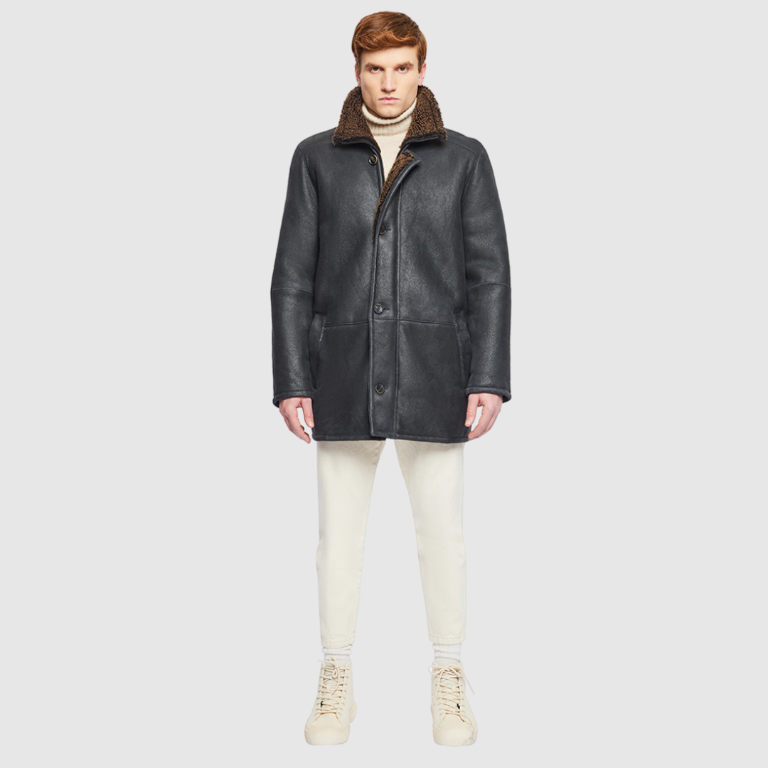 The Jakos Macassar Shearling Jacket is a sleek, contemporary take on a classic shearling coat. Crafted from nappa leather with a curly wool interior, it features a zippered stand collar and a two-way front zip closure concealed by a buttoned placket. Straight-cut through the torso with a regular fit, Jakos combines tailored structure with everyday versatility. Interior and exterior pockets provide functional storage without compromising its clean silhouette.
