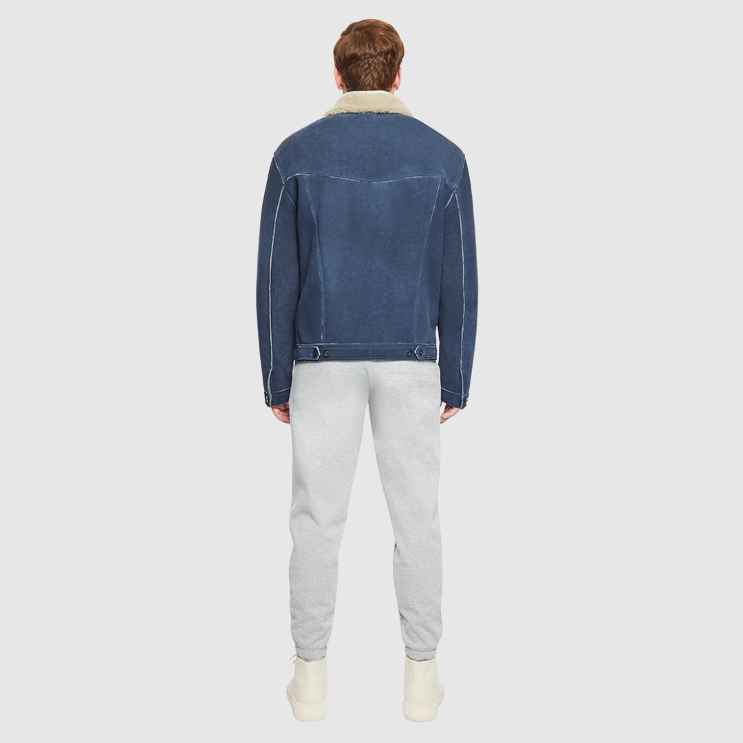 Suede with curly wool collar Regular shoulder Fitted through shoulders and chest Notch collar Buttoned cuffs and chest pockets Interior pouch pocket Single welt side pockets Front button closure