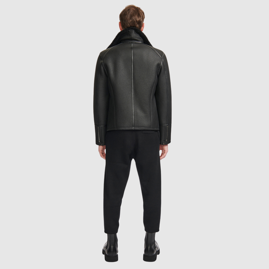The Logan Black Shearling Moto Jacket delivers a modern interpretation of the classic moto silhouette, crafted from supple nappa leather with a plush shearling lining. Designed to fit true to size, this jacket balances streamlined tailoring with rugged edge. An asymmetrical zip closure and spread collar reinforce its moto-inspired attitude, while an interior zip pocket provides discreet functionality. Refined yet versatile, Logan is a timeless investment piece built for cold-weather wear.