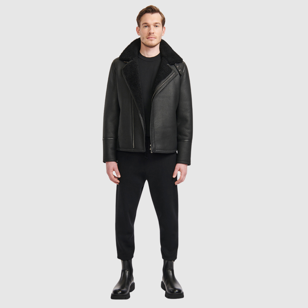 The Logan Black Shearling Moto Jacket delivers a modern interpretation of the classic moto silhouette, crafted from supple nappa leather with a plush shearling lining. Designed to fit true to size, this jacket balances streamlined tailoring with rugged edge. An asymmetrical zip closure and spread collar reinforce its moto-inspired attitude, while an interior zip pocket provides discreet functionality. Refined yet versatile, Logan is a timeless investment piece built for cold-weather wear.