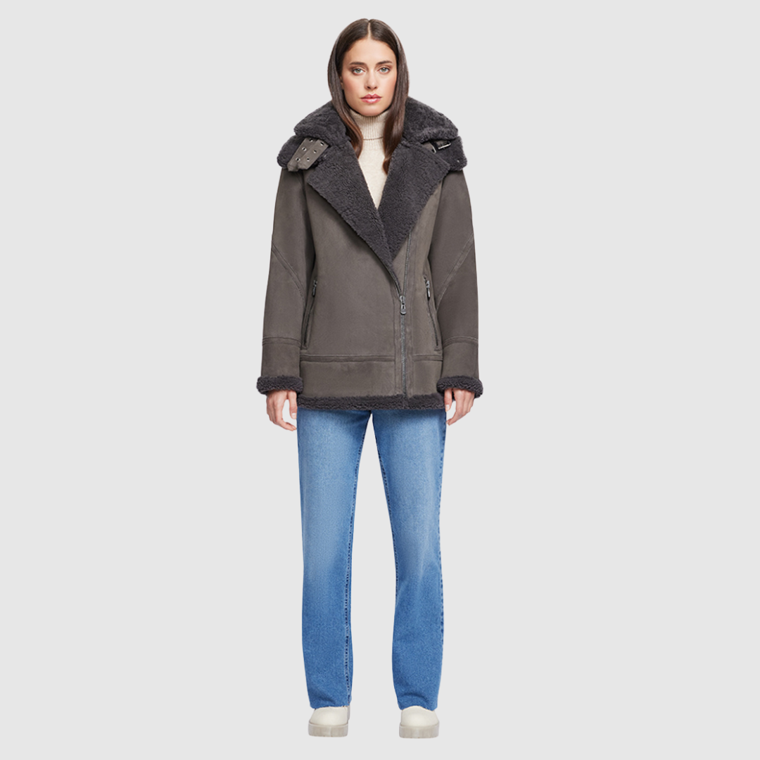 Expertly crafted with a suede exterior, this moto jacket boasts a relaxed fit and medium length for added comfort. The luxurious shearling collar and trims perfectly complement the drop shoulder design, while the detachable hood offers versatility. With an asymmetrical front zip closure, exterior zip pockets, and hidden inside pockets, this jacket is both stylish and functional.