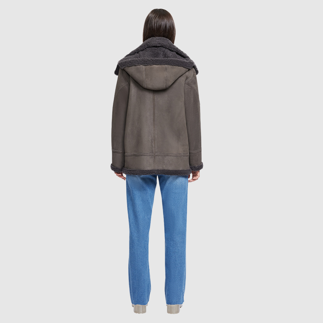 Expertly crafted with a suede exterior, this moto jacket boasts a relaxed fit and medium length for added comfort. The luxurious shearling collar and trims perfectly complement the drop shoulder design, while the detachable hood offers versatility. With an asymmetrical front zip closure, exterior zip pockets, and hidden inside pockets, this jacket is both stylish and functional.