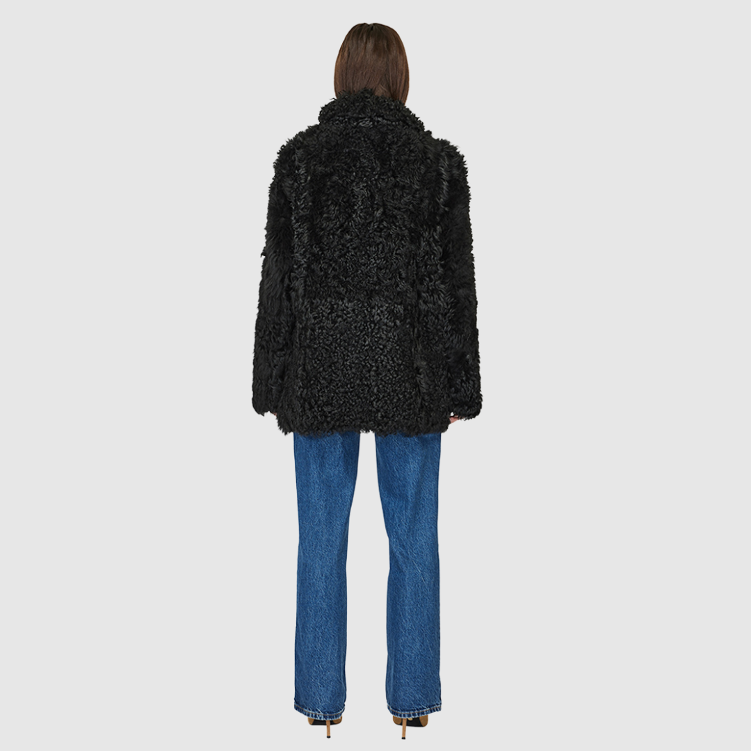 This reversible jacket features a curly toscana rasado teddy on one side and a semi suede skin-out on the other. When worn with the wool-out side, it has a relaxed fit, but when worn with the skin-out side, it has a regular fit. It also includes a spread collar, slash side pockets on the toscana teddy side, patch side pockets on the semi suede side, and a 4 button front closure.