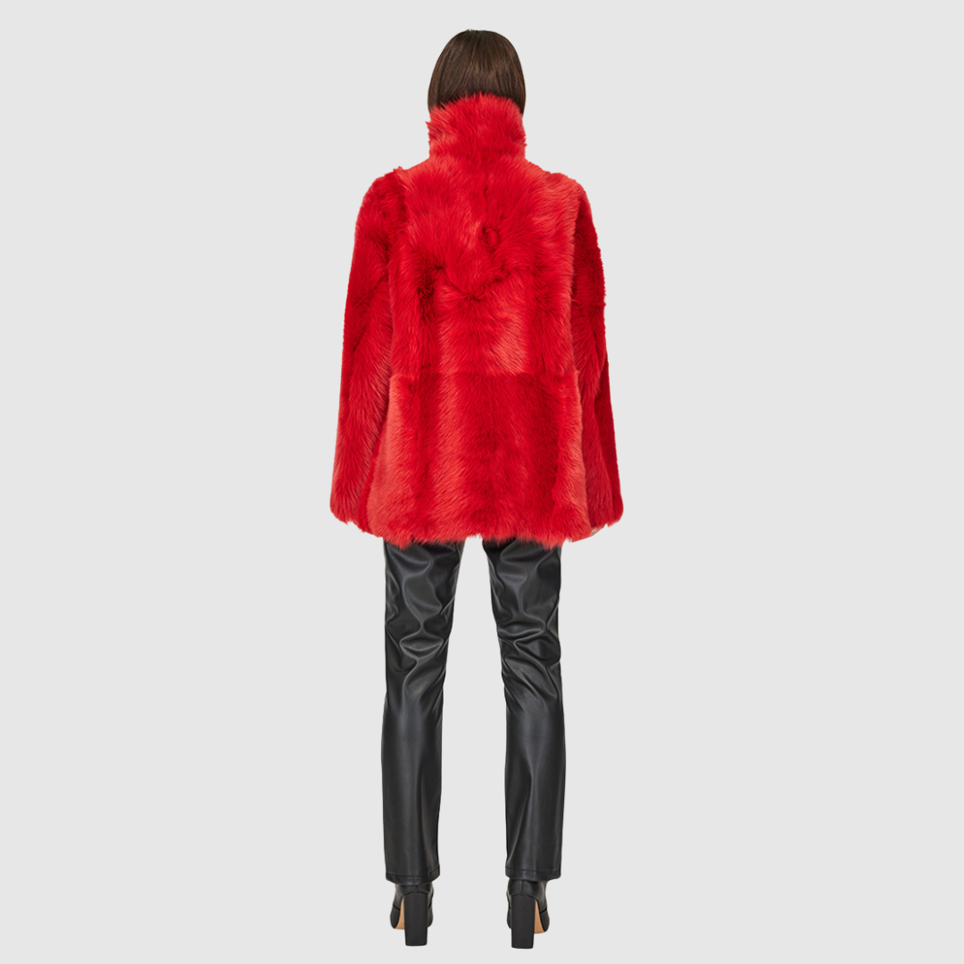 This HiSO Milky Way Racing Red Reversible Shearling Teddy is versatile and stylish. It can be worn with a relaxed fit showcasing the wool-out side, or with a regular fit highlighting the suede side. The jacket features a spread collar, slash side pockets on the toscana teddy side, and patch side pockets on the suede side. It is secured with a front button closure.