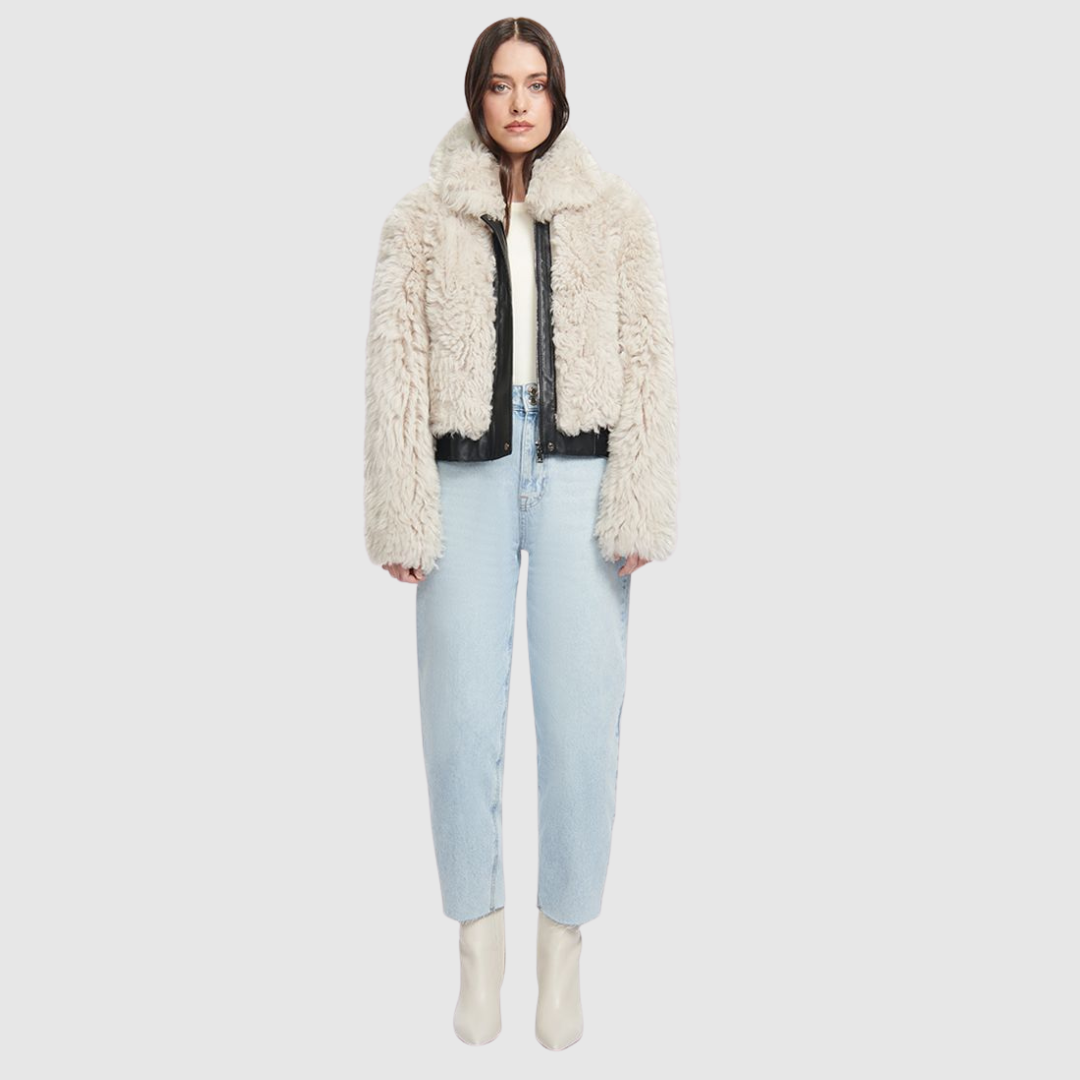 This HiSO Parma Parchment Shearling Bomber boasts a stylish design with a drop shoulder and Nappa leather trims. Made with curly toscana wool-out material, it features slash side pockets and a front zip and button closure for convenience and functionality.