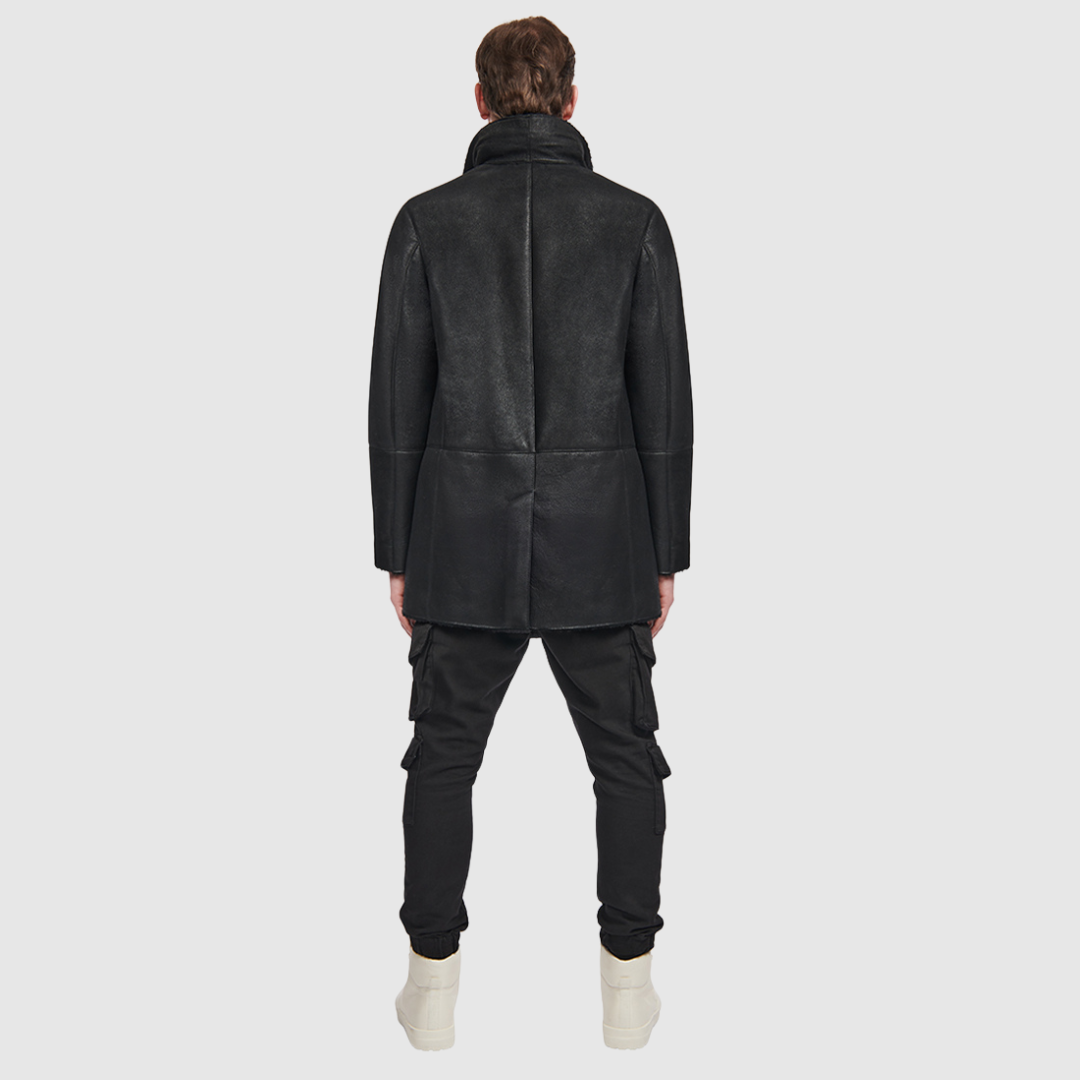 Shearling from Spain Curly wool collar Dyed shearling lamb Notch lapel Button placket Exterior lined front pockets Interior zipped pockets Metal and leather logo tag on inside