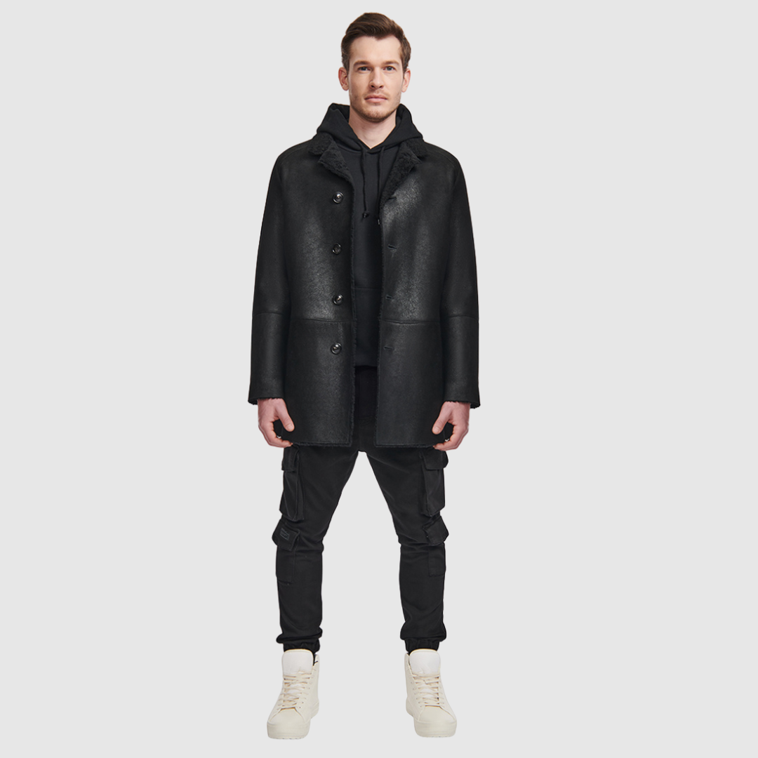 Shearling from Spain Curly wool collar Dyed shearling lamb Notch lapel Button placket Exterior lined front pockets Interior zipped pockets Metal and leather logo tag on inside