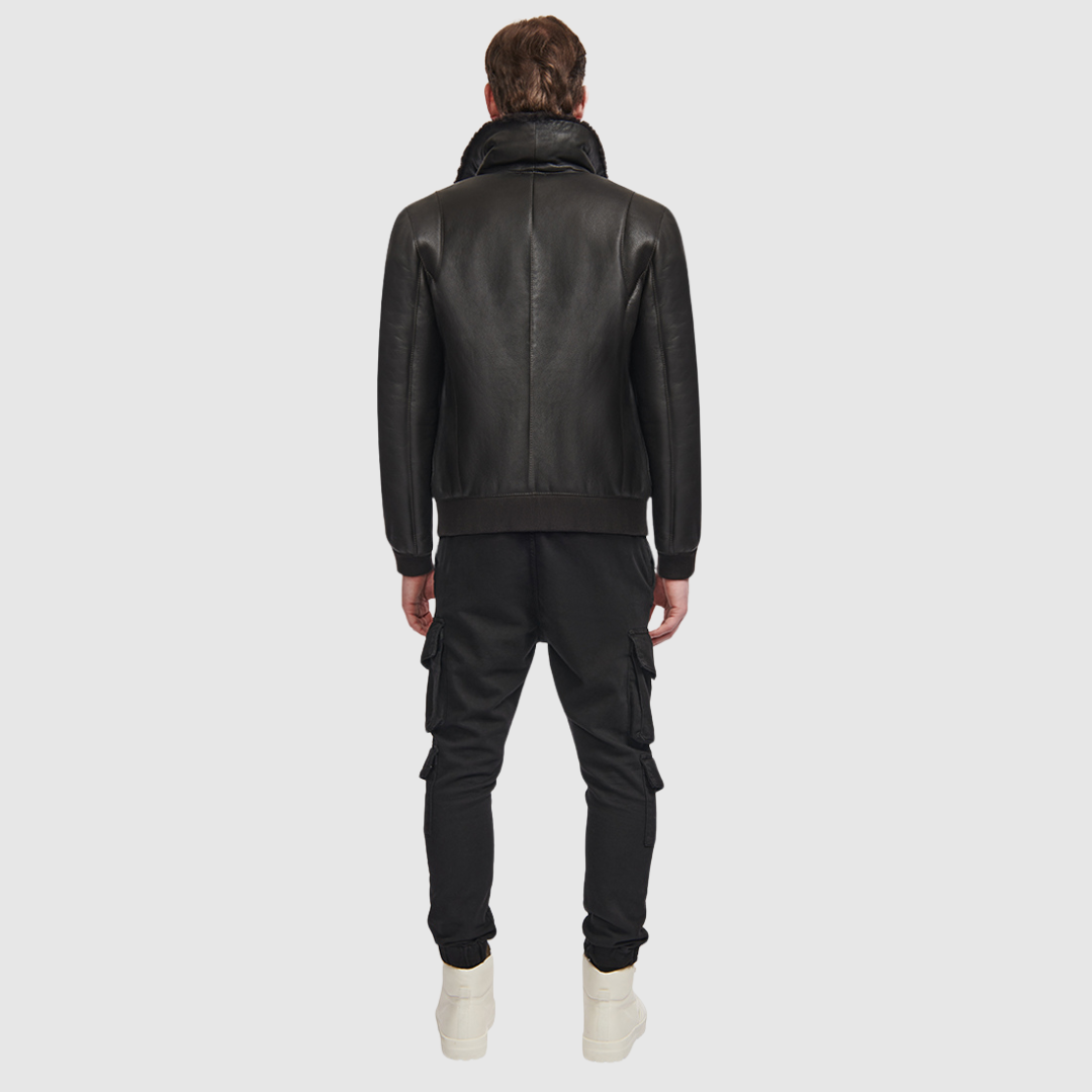 The Seth Dark Brown Shearling Bomber delivers a modern interpretation of a heritage bomber jacket, crafted from supple nappa leather and lined with plush shearling. Designed to fit true to size, it features a spread collar for timeless appeal, oversized flap pockets for utility, and ribbed cuffs and waistband to create a structured silhouette. A standard front zip closure and an interior zip pocket complete this versatile cold-weather essential.