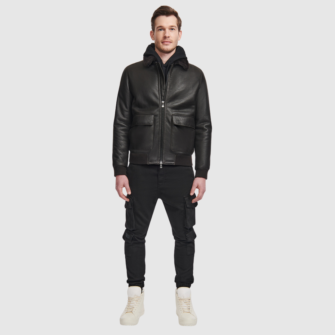 The Seth Dark Brown Shearling Bomber delivers a modern interpretation of a heritage bomber jacket, crafted from supple nappa leather and lined with plush shearling. Designed to fit true to size, it features a spread collar for timeless appeal, oversized flap pockets for utility, and ribbed cuffs and waistband to create a structured silhouette. A standard front zip closure and an interior zip pocket complete this versatile cold-weather essential.