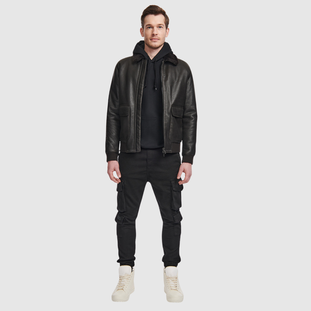 The Seth Dark Brown Shearling Bomber delivers a modern interpretation of a heritage bomber jacket, crafted from supple nappa leather and lined with plush shearling. Designed to fit true to size, it features a spread collar for timeless appeal, oversized flap pockets for utility, and ribbed cuffs and waistband to create a structured silhouette. A standard front zip closure and an interior zip pocket complete this versatile cold-weather essential.