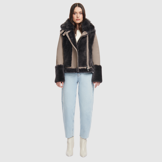 This sleek moto is designed with a high stand collar with double buckle detail and an asymmetrical front zip closure. Crafted in genuine shearling, the jacket is finished with side zip pockets and an interior pocket. Genuine Shearling Stand collar Long-sleeve Zipper closure Imported