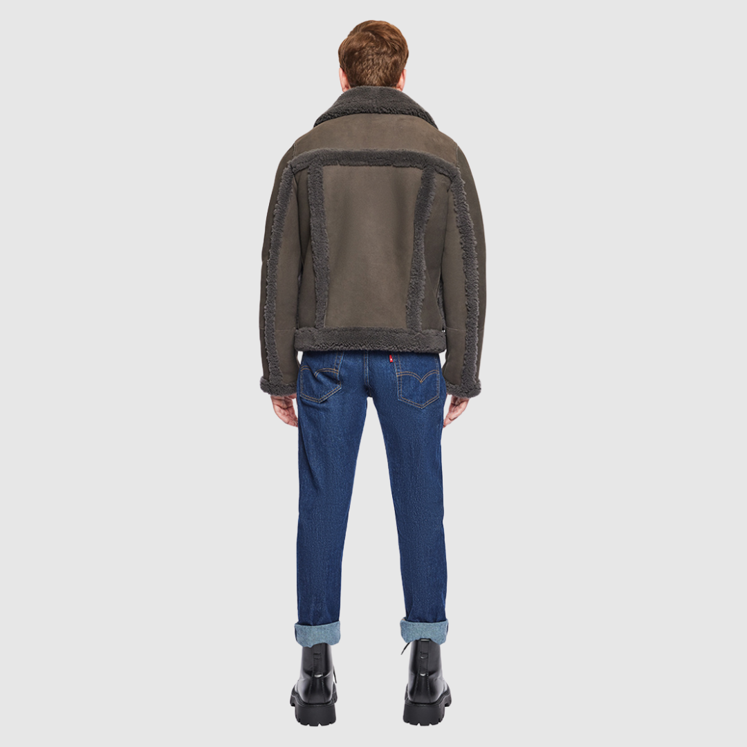 The Umberto Cappuccino Shearling Jacket combines mixed-media suede construction with luxe curly wool detailing for a contemporary twist on classic outerwear. Designed with a regular shoulder and a comfortable fit through the shoulders and chest, it features contrast curly wool seam details and a spread collar with buckle accents. Side zip patch pockets and a front zip closure offer both functionality and refined design.