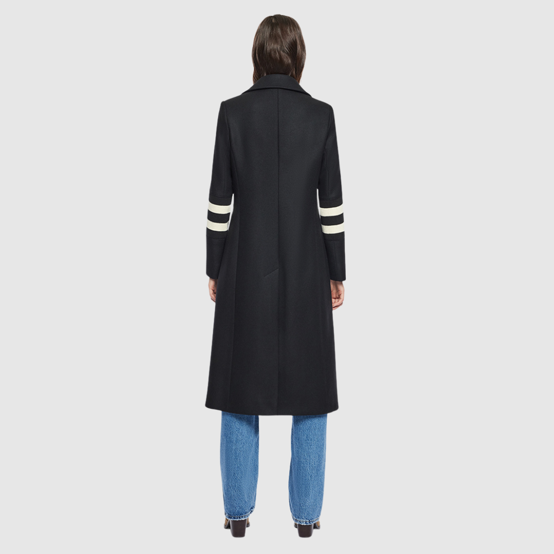 The YVETTE black wool is crafted from a luxurious Italian wool-cashmere blend, designed in a semi-fitted A-line silhouette that balances structure with ease. Its double-breasted closure and regular shoulder create a timeless, tailored line, while knit stripe detailing at the arms adds a subtle modern edge. Finished with a notch collar and functional slash pockets, YVETTE is a sophisticated outerwear piece that combines refinement with everyday versatility.