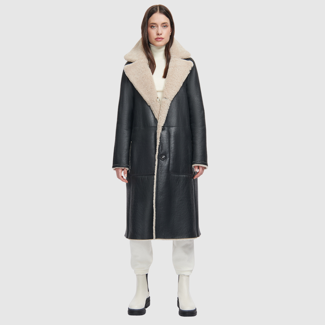 This product features Nappa curly wool shearling with a vintage-inspired, reversible notch collar. On one side, you'll find a soft teddy bear-like texture, while the other boasts a smooth nappa finish. The relaxed, dropped shoulder adds to the overall comfort, and the 3-button closure allows for a secure fit. A tie belt is included for added style on the reversed side, and there are zip pockets on the nappa side, with patch pockets on the teddy side.